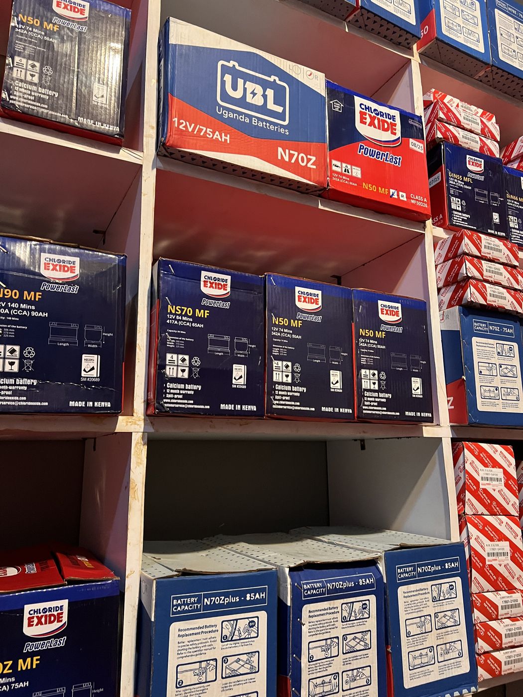 Close-up of UBL and Chloride Exide battery stock and genuine Toyota parts at Makanga Auto Centre